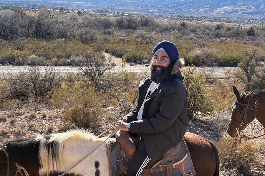 Angad riding a horse in Alaska.